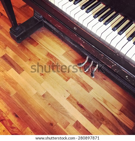 Vintage piano on old wooden floor, view from top.
