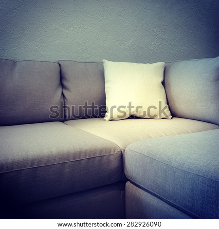 Corner sofa with white cushion. Modern furniture.