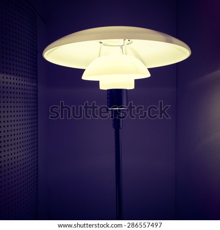 Lamp with stylish design illuminating a dark room.
