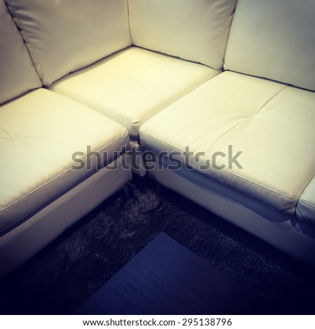 White corner leather sofa and coffee table. Modern furniture.