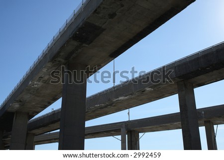 Side view of urban highway viaducts against the blue sky.