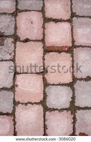 Stone tile paving pattern, with wet cement after the rain.