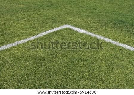 Corner boundary lines of a green grass playing field.