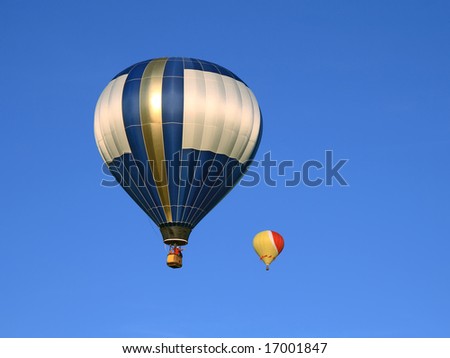Two beautiful hot air balloons in the blue sky.