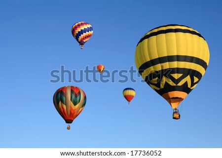 Many beautiful hot air balloons in the clear sky.