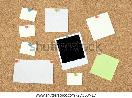 Post-it notes of different sizes and a blank photo pinned to corkboard.