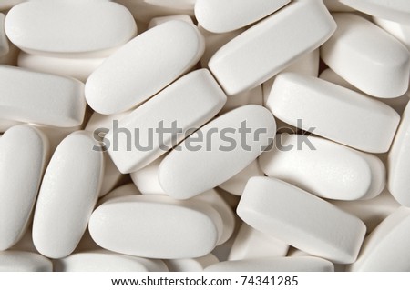 Medical background, close-up of big white pills.