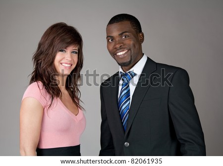 Young smiling business partners, Caucasian woman and African American man.