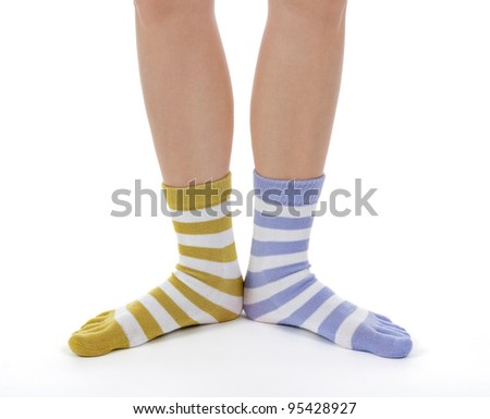 Funny legs in socks of different colors on white background.