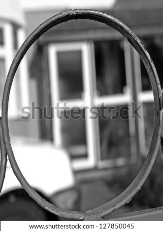 A metal image in black and white taken in a way to make the letter o. the image was shot at day time with a ISO of 100, shutter speed of 1,500, f stop of 5.0 to give the image a blurred look .