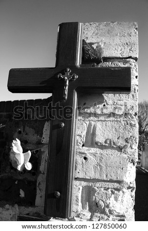 a  cross image in black and white taken in a way to make the letter look like a T.The image was shot at day time with a ISO of 100 Shutter speed of  60, f stop of 14 to give  sharp look.