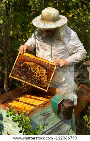 The beekeeper has control over a framework with honey