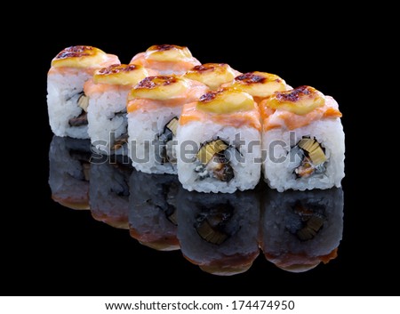 Baked sushi set with salmon, eel and omelet on black background
