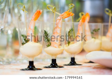 Glasses with seafood snacks close-up