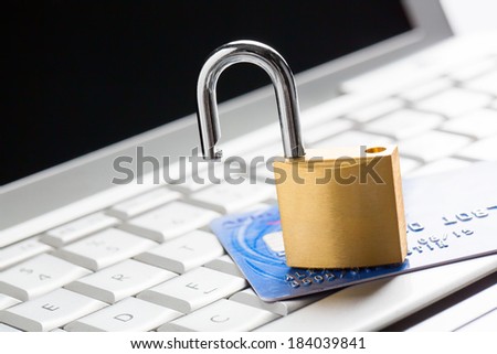 Unlocked padlock on a credit card on keyboard