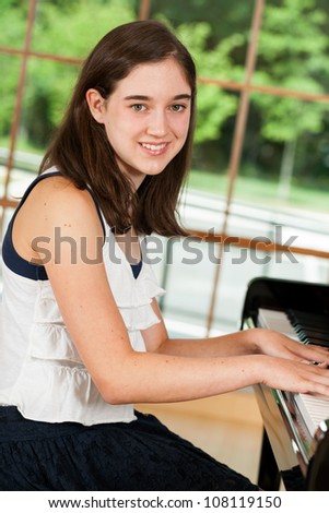 Young tween pianist playing the piano