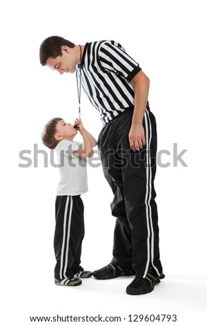 A 4 year old boy blowing teen referee\'s whistle isolated on a white background