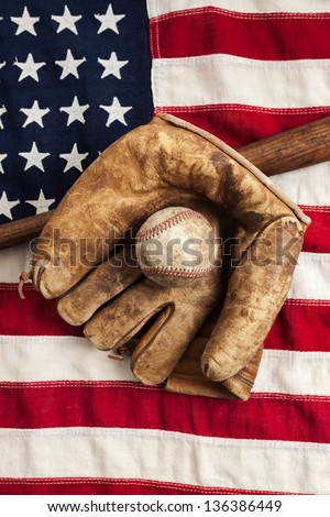 Vintage baseball, glove and bat on an American flag