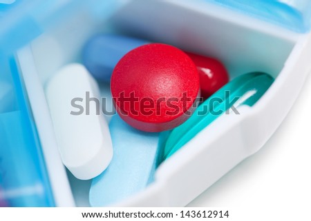 Open pill container with colorful medication