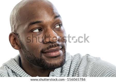 Head and shoulders portrait of a handsome late 20s black man looking over his shoulder isolated on white background