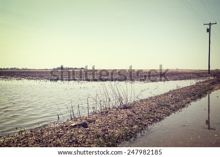 Flooded farmland in rural American after heavy spring rains with vintage filtered effect