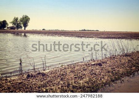 Flooded farmland in rural American after heavy spring rains with vintage filtered effect