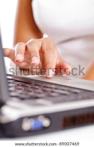 Young woman tapping the mouse pad on a laptop