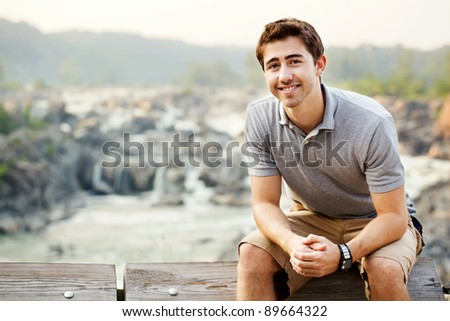 Young man sitting at a waterfall park in Great Falls Virginia