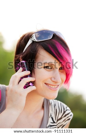 Young punk woman on a cell phone