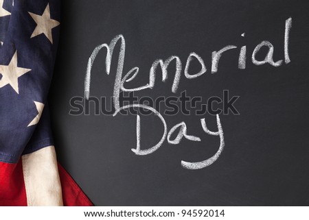 Memorial Day holiday sign written on a chalkboard with vintage American flag