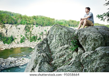 Young man on a cliff at Great Falls National Park in Virginia