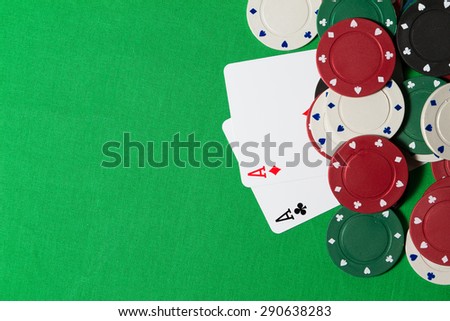 playing cards with chips on a green table
