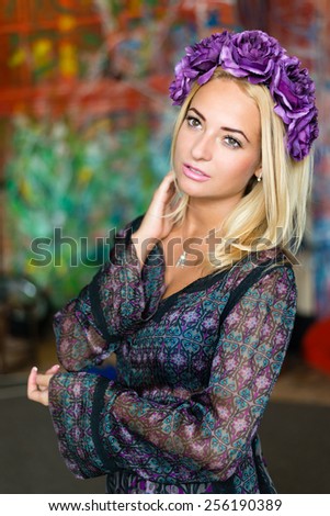 Beauty portrait of young pretty woman with flower wreath in her hair