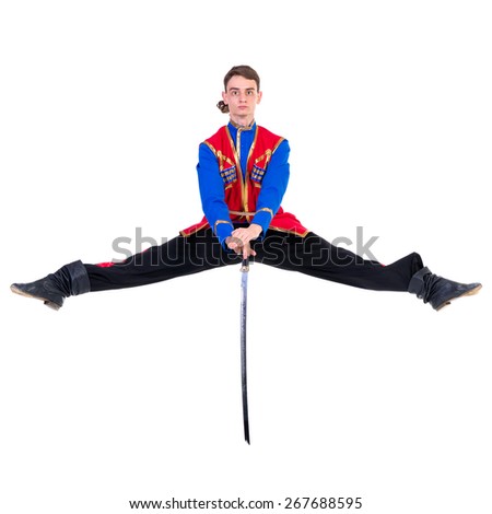 Russian cossack dance. Young dancer in ethnic clothes jumping over a sword.  full length portrait isolated over white background