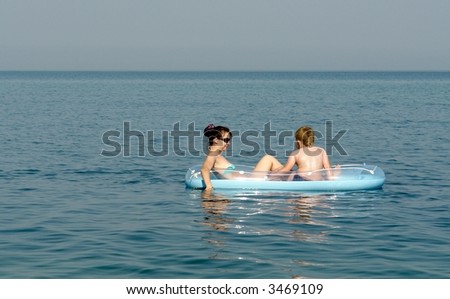 The woman and the child on an inflatable boat in the sea