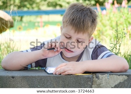 The little boy writes to writing-books