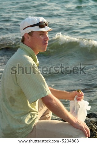Young man with a bottle in profile of water