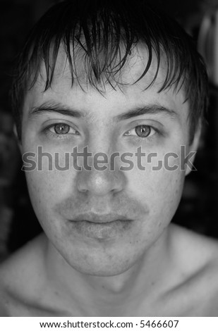 Black-and-white portrait. A man\'s face close up