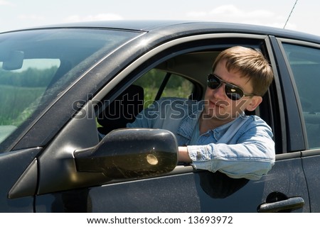 smiling young man in the car