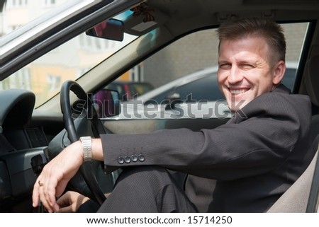 smiling young man in the car