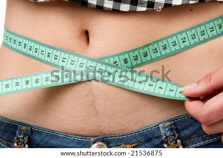 Dieting woman with measuring tape close up