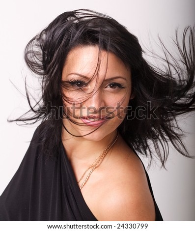 Wind. Attractive woman with crazy hair close up.