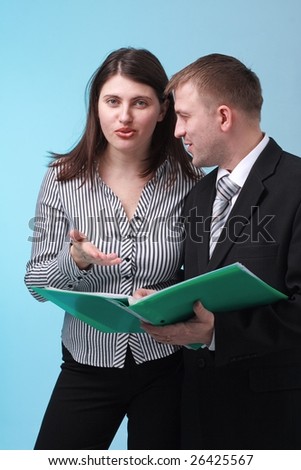 Business people reading documents against blue background.