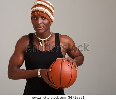 young man with basketball on a gray background