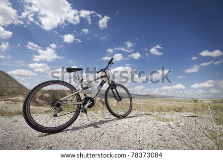 Mountain bicycle and cloudy blue sky