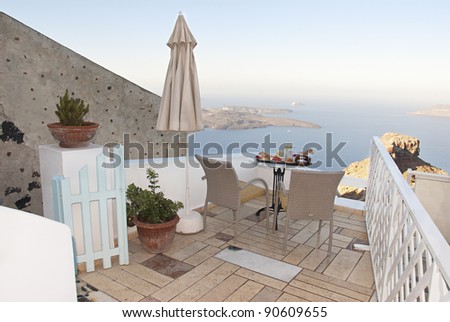 Balcony view at the Santorini and breakfast table near the sea