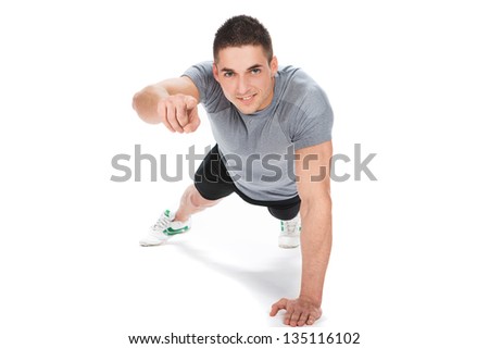 muscle model guy making push ups exercise over gray background.