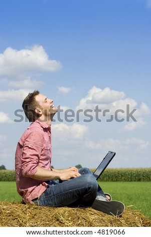 handsome man with laptop over country view