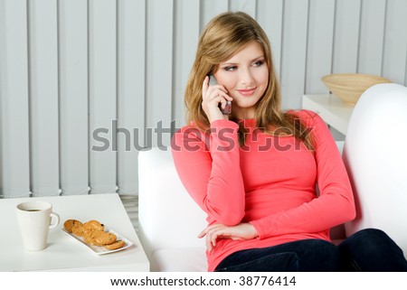 Casual woman at home on the couch using cellphone
