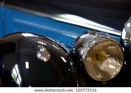 part of a black old car with headlamp